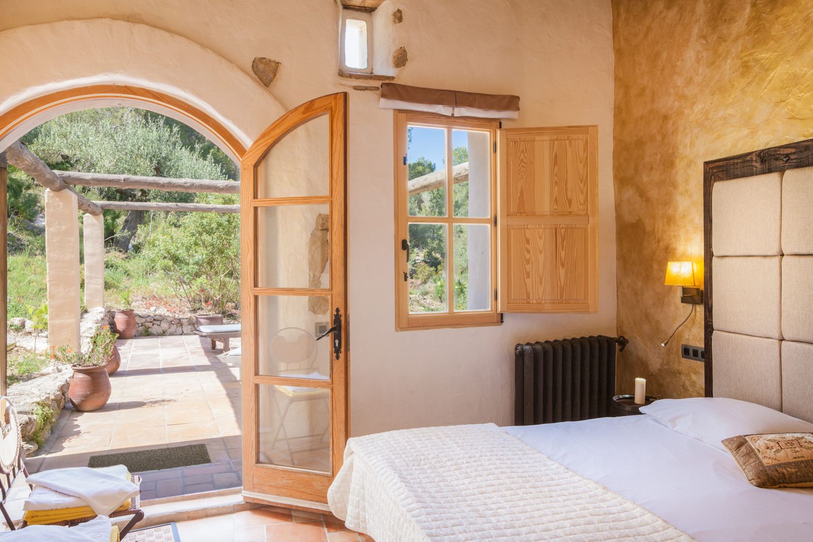 Bedroom with doors open to the garden